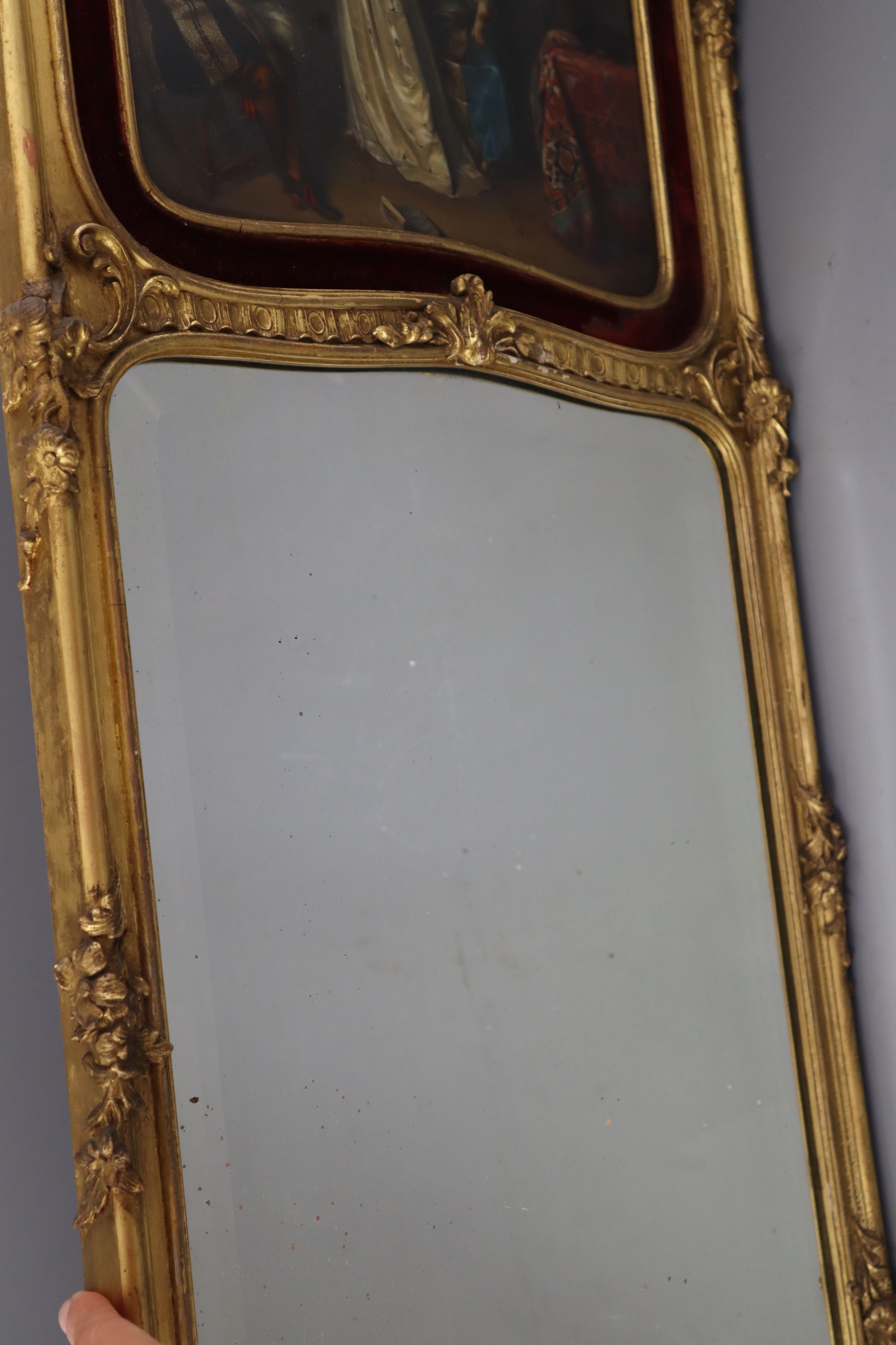 A late 19th century carved giltwood wall mirror, W.43cm overall H.104cm